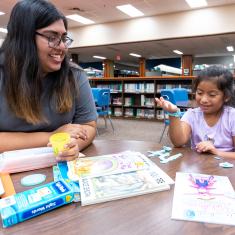 Summer Reads Mentor helps a child play and learn.