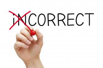 hand crossing off the i n at the front of the word incorrect with a red marker